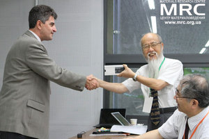 Prof. Gogotsi is giving a present to prof. Yoshimura