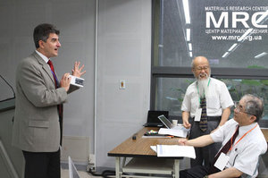 Prof. Gogotsi is giving a present to prof. Yoshimura