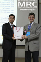 Dr. YuryGogotsi is receiving a present from session chair